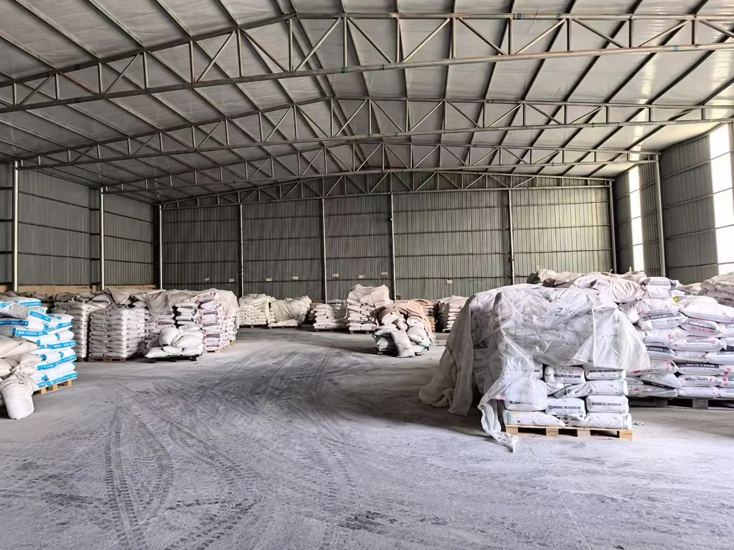 Covered warehouse with bagged materials stored on pallets
